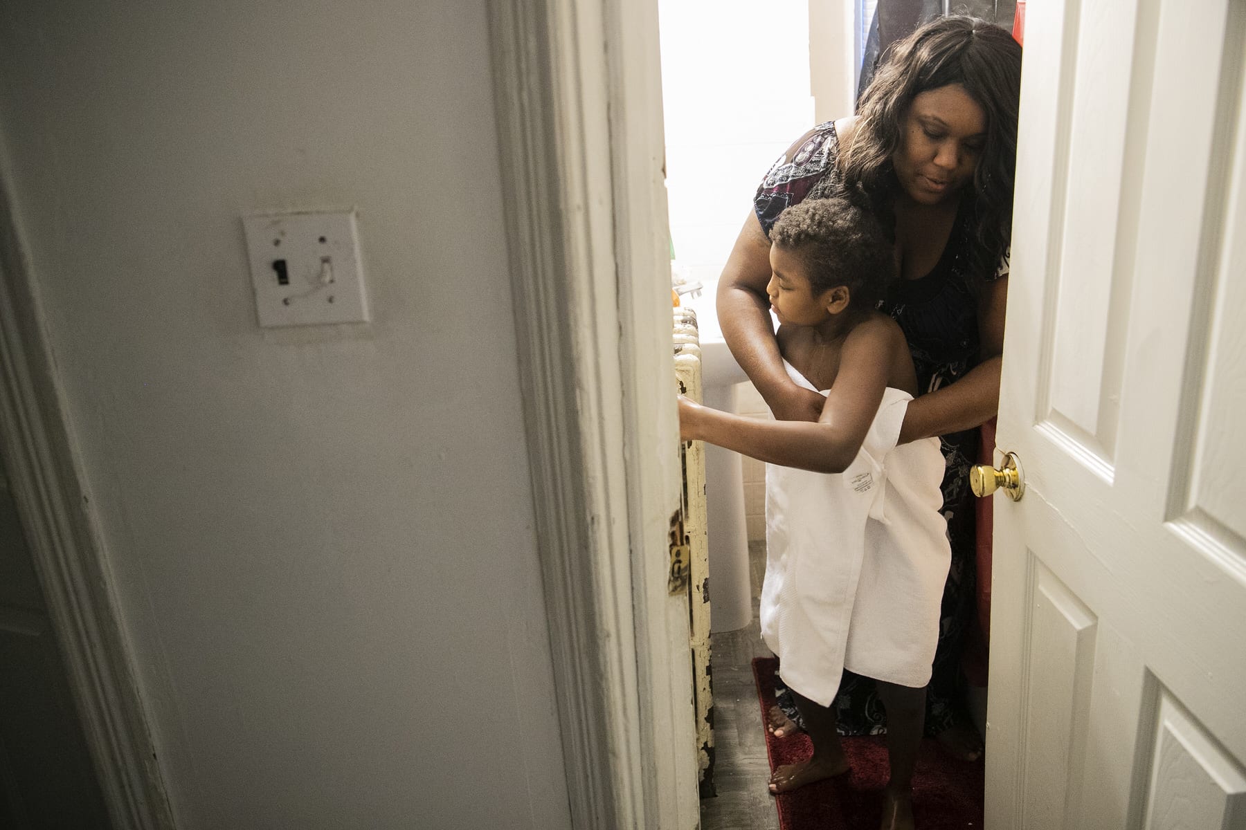 Syrita Powers helping dress her daughter Georgia.