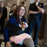 U.S. Sen. Tammy Duckworth (D-IL) leaves the Senate Chamber after a vote with her newborn baby daughter Maile Pearl Bowlsbey at the U.S. Capitol on Take Your Daughters and Sons To Work Day, April 26, 2018