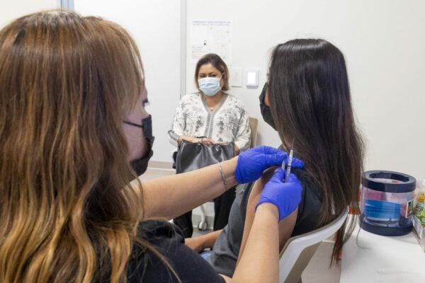 APRIL 28: A 16-year-old gets a Pfizer-BioNTech COVID-19 vaccine from Marie Thai, RN at UCI Health Family Health Center in Anaheim, CA on Wednesday, April 28, 2021 as her mom watches.