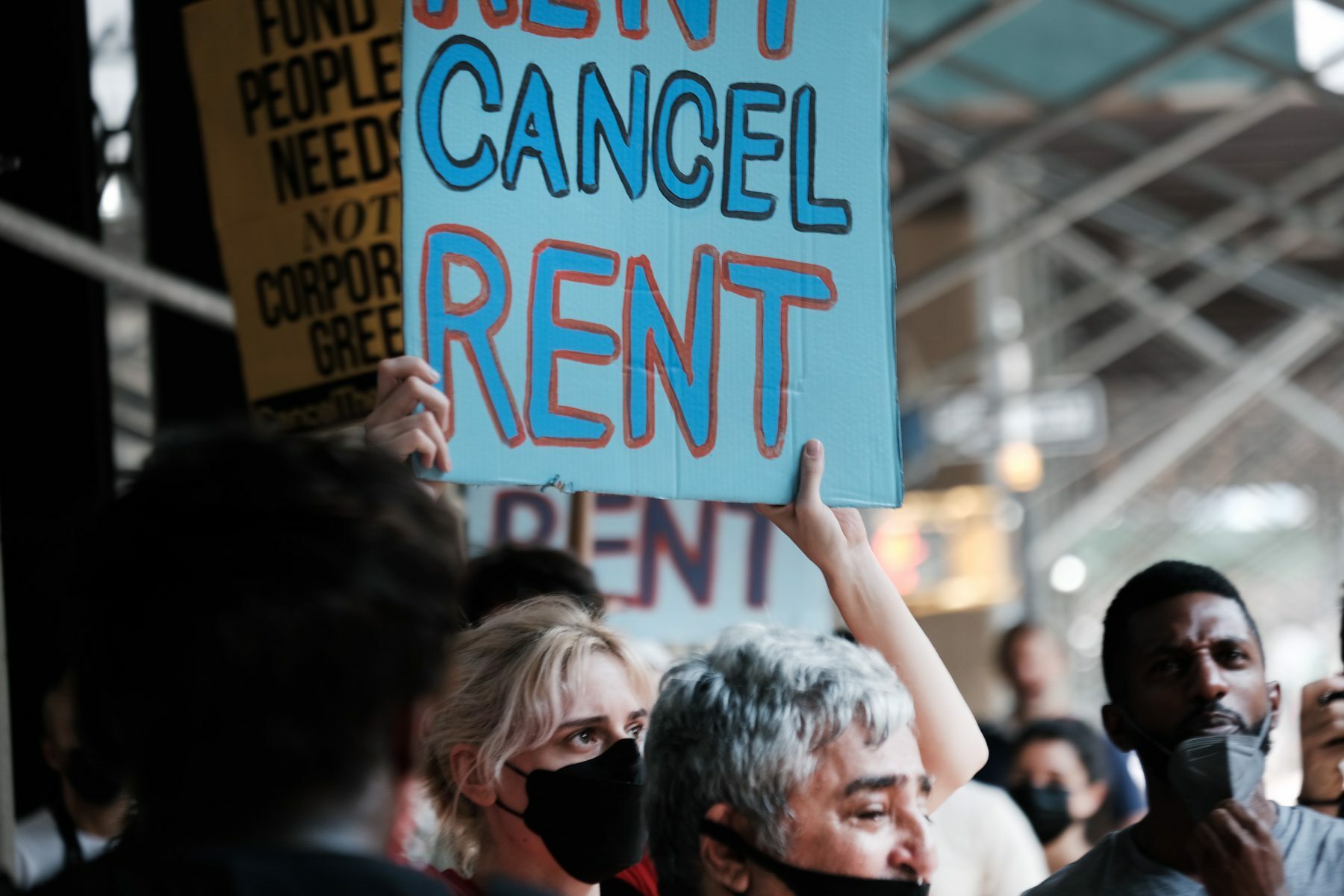 Protester holding a sign that says cancel rent.