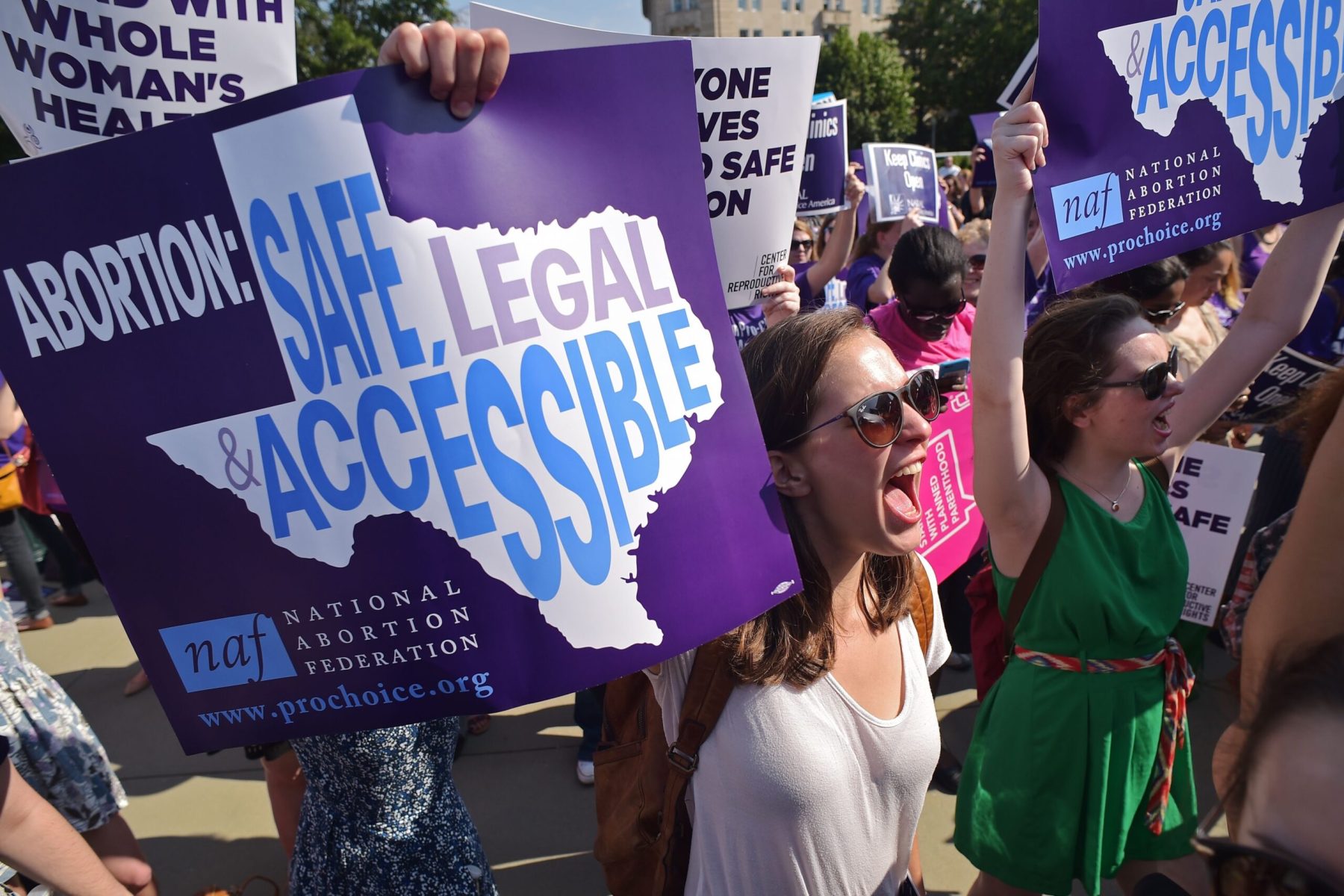 Abortion rights activists hold placards and chant outside of the US Supreme Court.