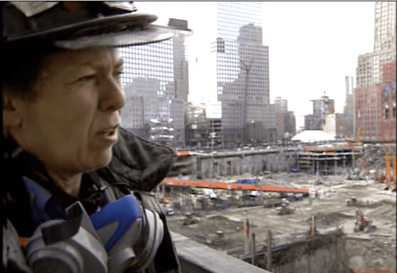 A woman firefighter standing at ground zero.