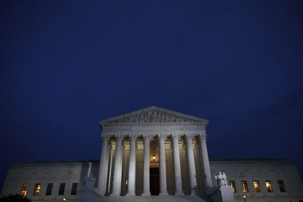 A view of the front of the Supreme Court building at dusk.