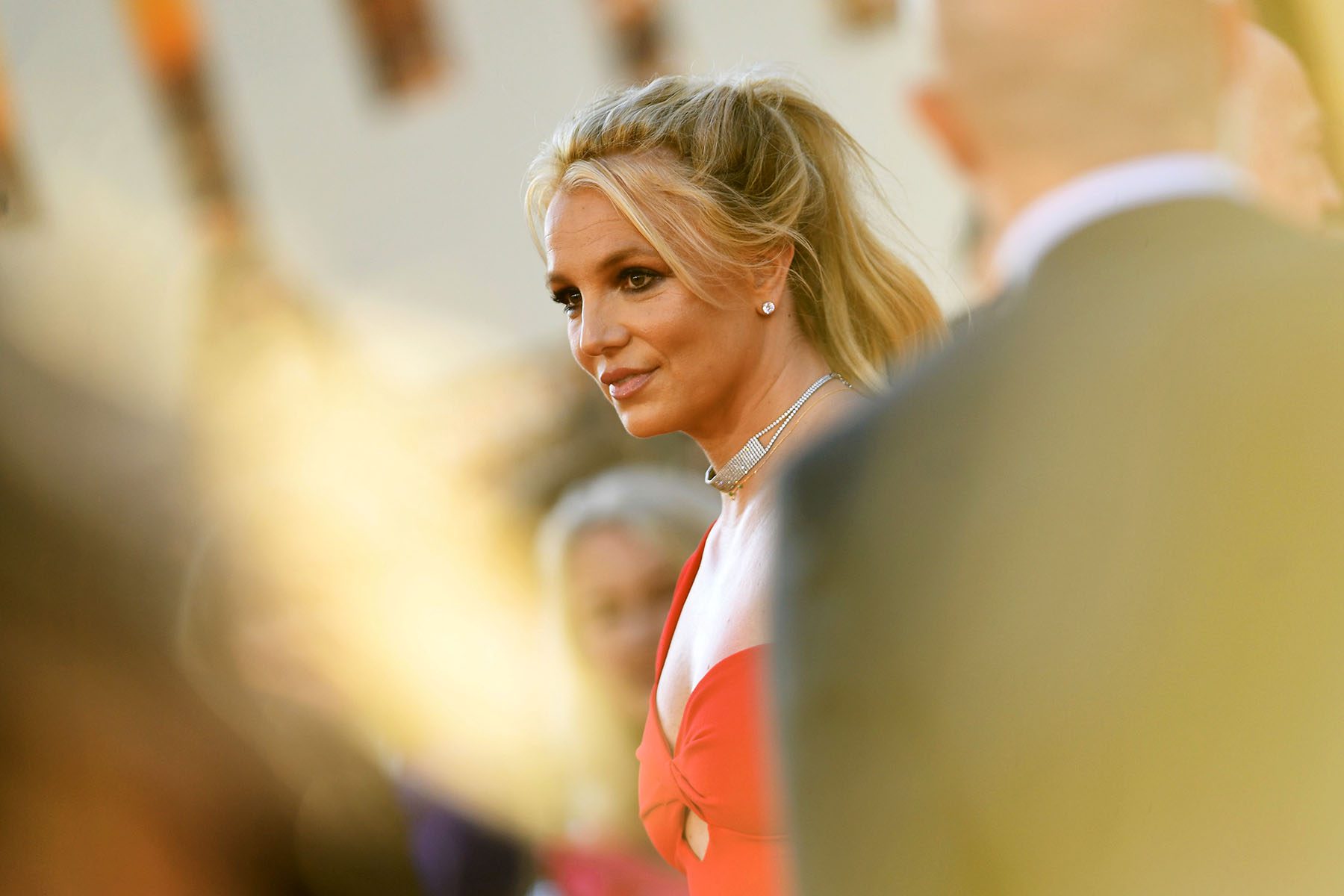 Britney Spears is seen wearing a red dress at a movie premiere.