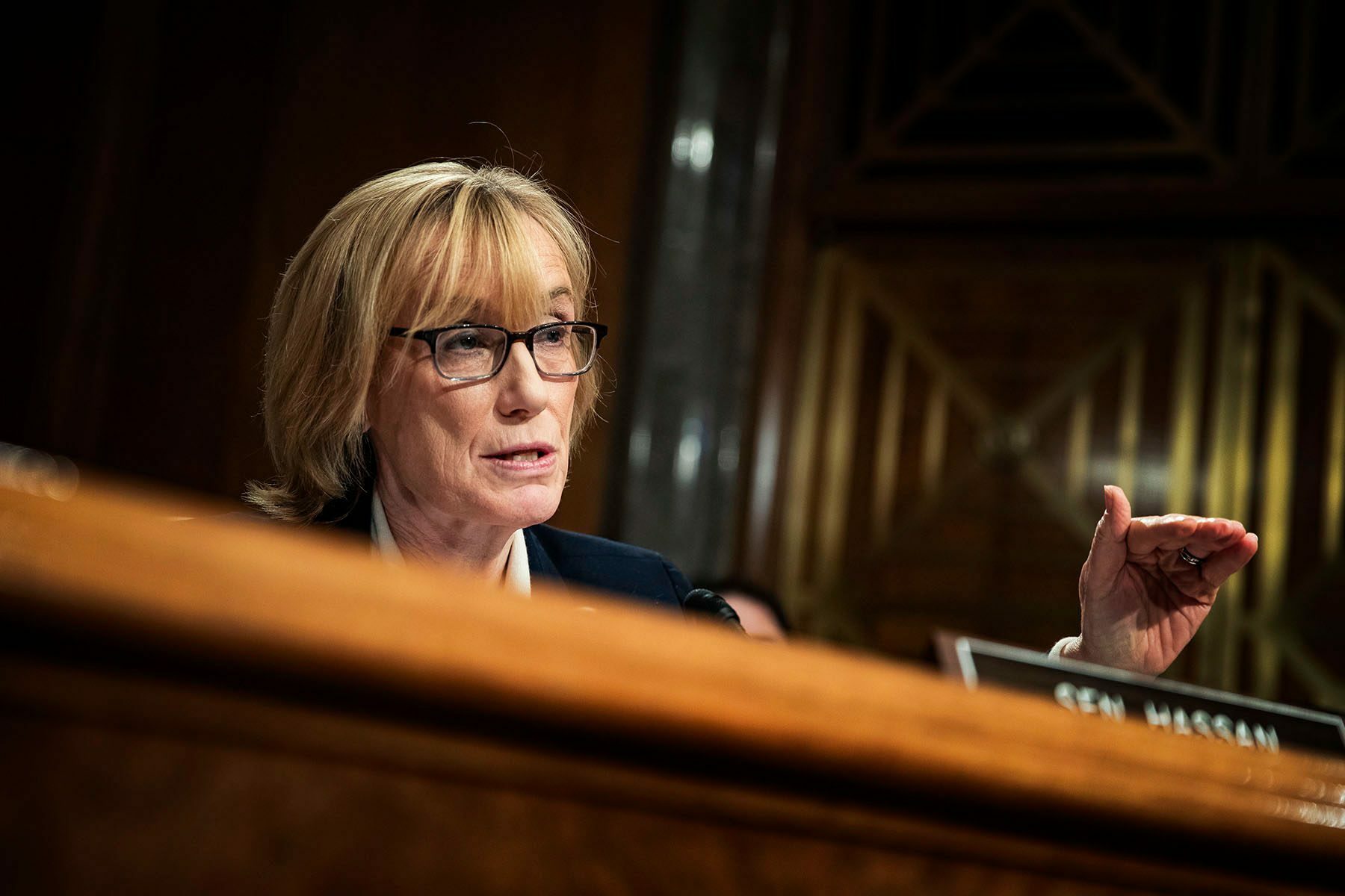Margaret Hassan is seen at behind a desk while she speaks in Congress.