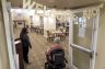 A woman enters the dining room of a nursing home