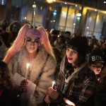 Activists hold candles during a vigil in remembrance of transgender friends lost to murder and suicide.