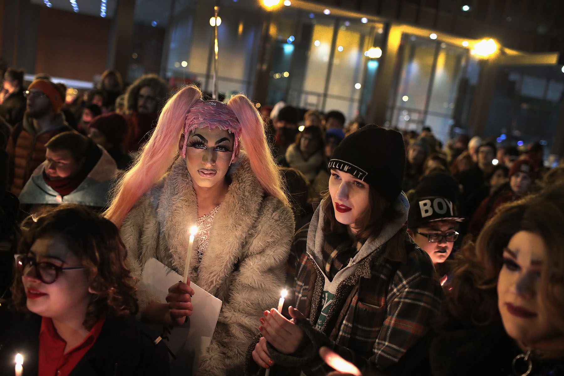 Activists hold candles during a vigil in remembrance of transgender friends lost to murder and suicide.