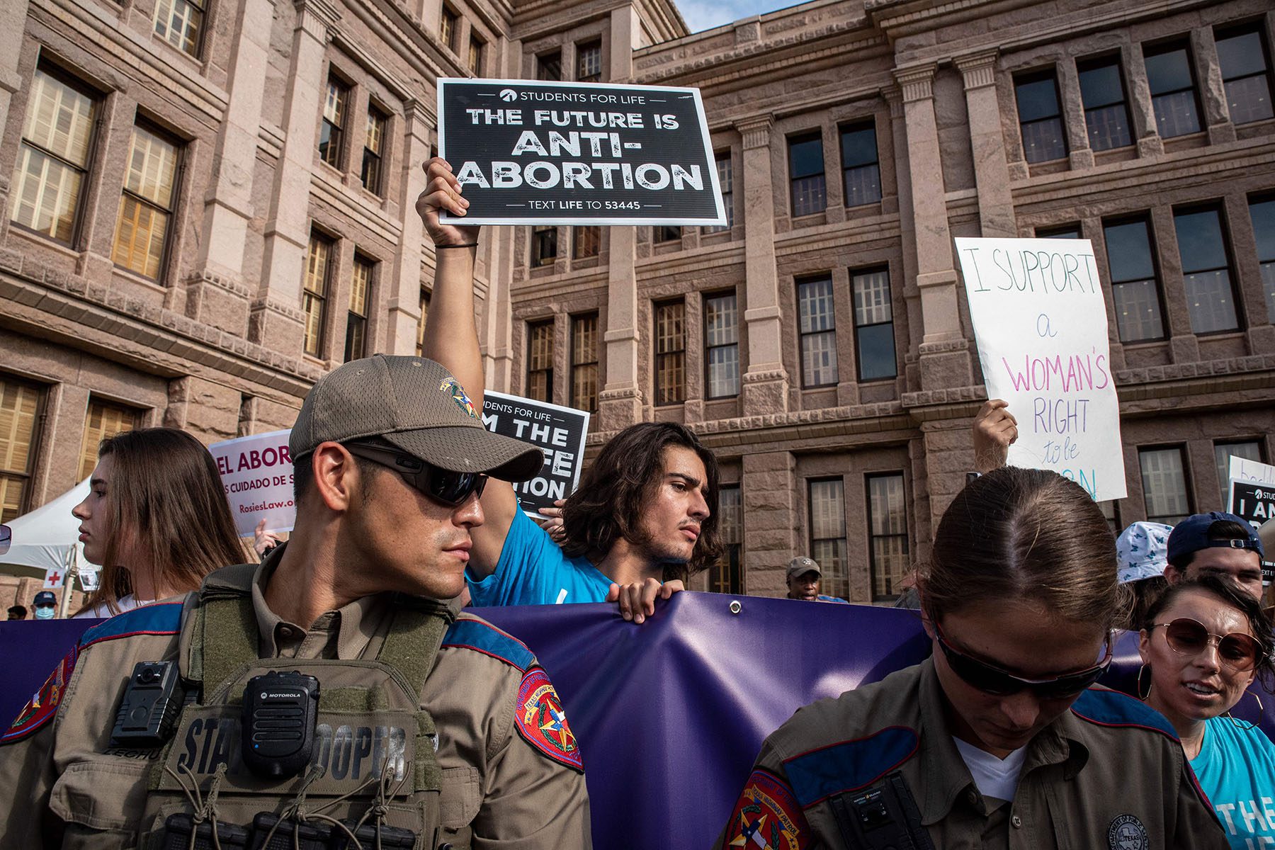 State troopers watch as people anti-abortion rights activists protest in front of the Texas State Capitol.