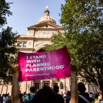 An abortion rights activist holds a sign in support of Planned Parenthood at a rally at the Texas State Capitol.