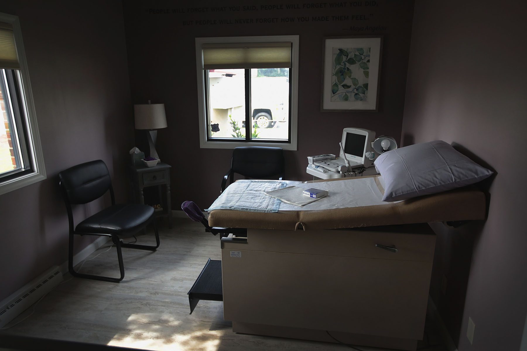 An ultrasound machine sits next to an exam table in an examination room.