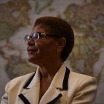 Karen Bass poses for a portrait in front of a wold map.