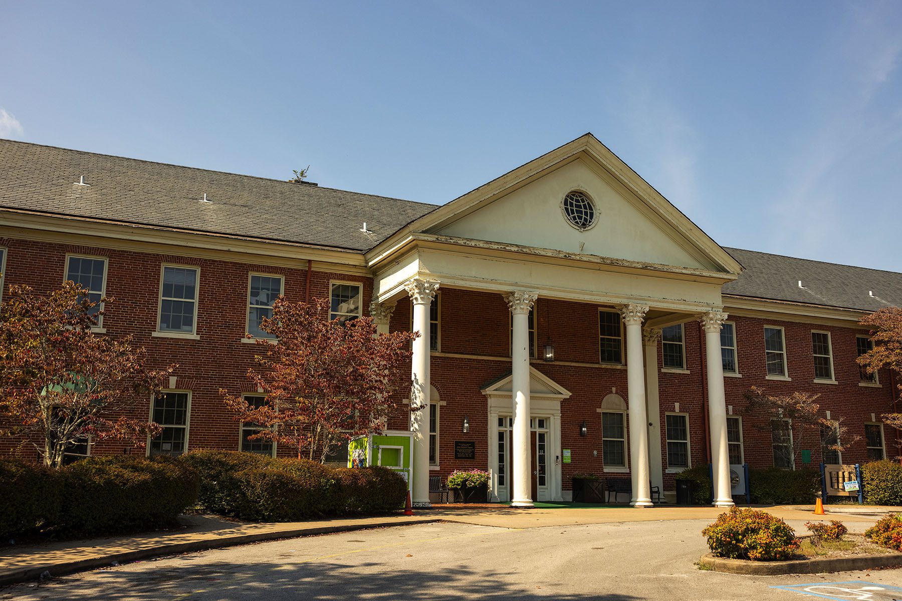 An image of Chambliss’s main campus standing under a blue sky. The brick building is imposing, with four columns at its entrance.