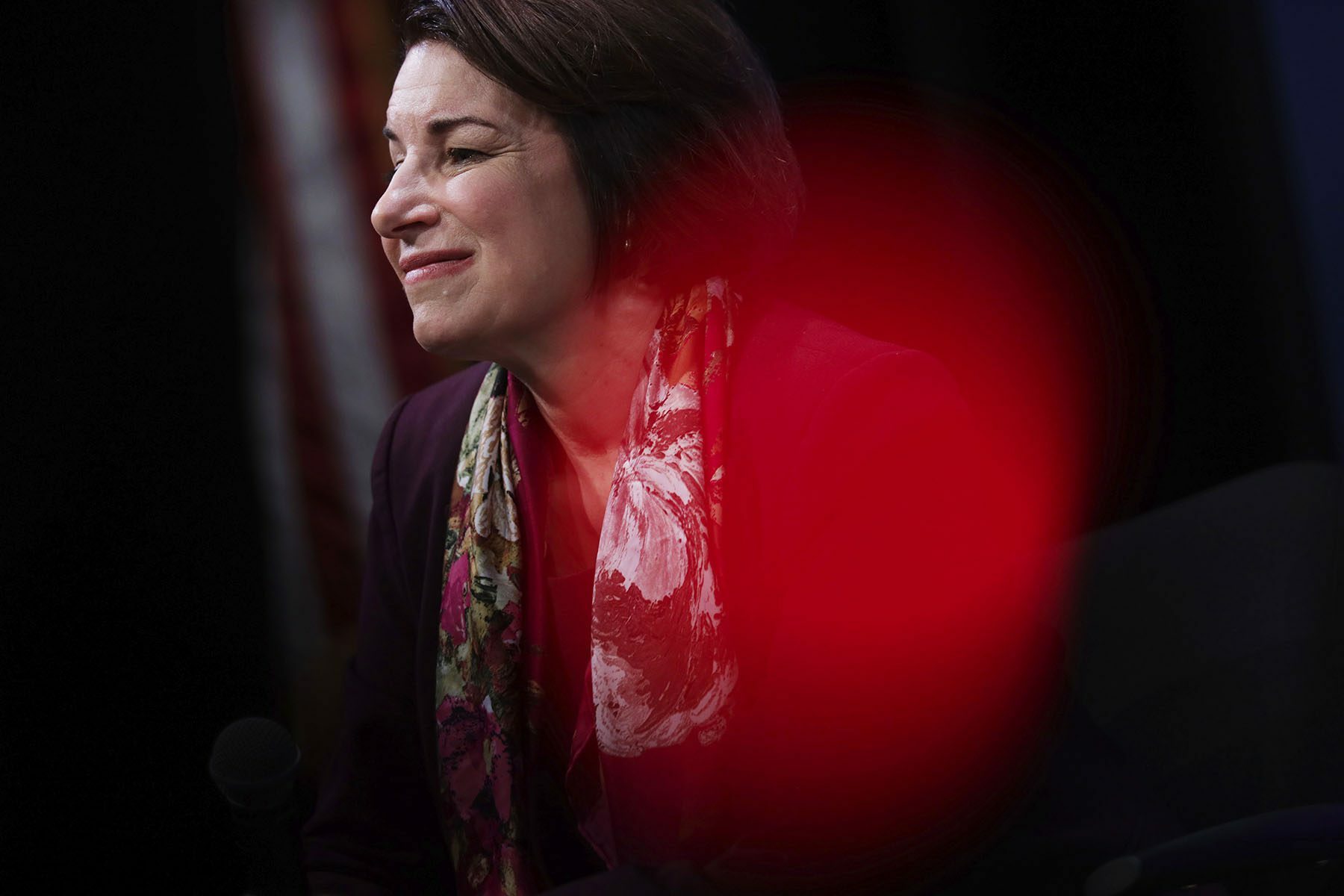 Sen. Amy Klobuchar looks to the side and smiles.