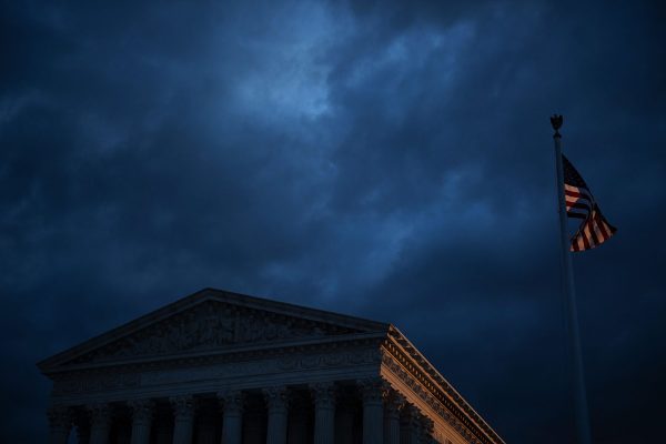 A view of the U.S. Supreme Court under a cloudy sky.