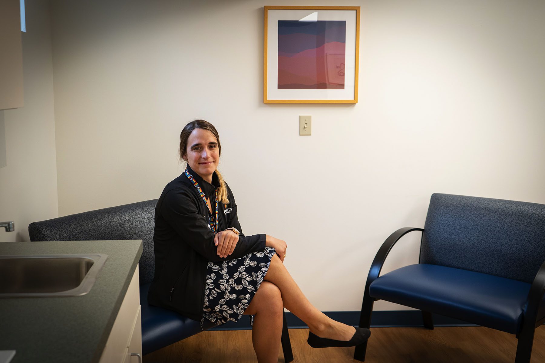 Dallas Ducar sits on a large chair inside the TransHealth clinic.