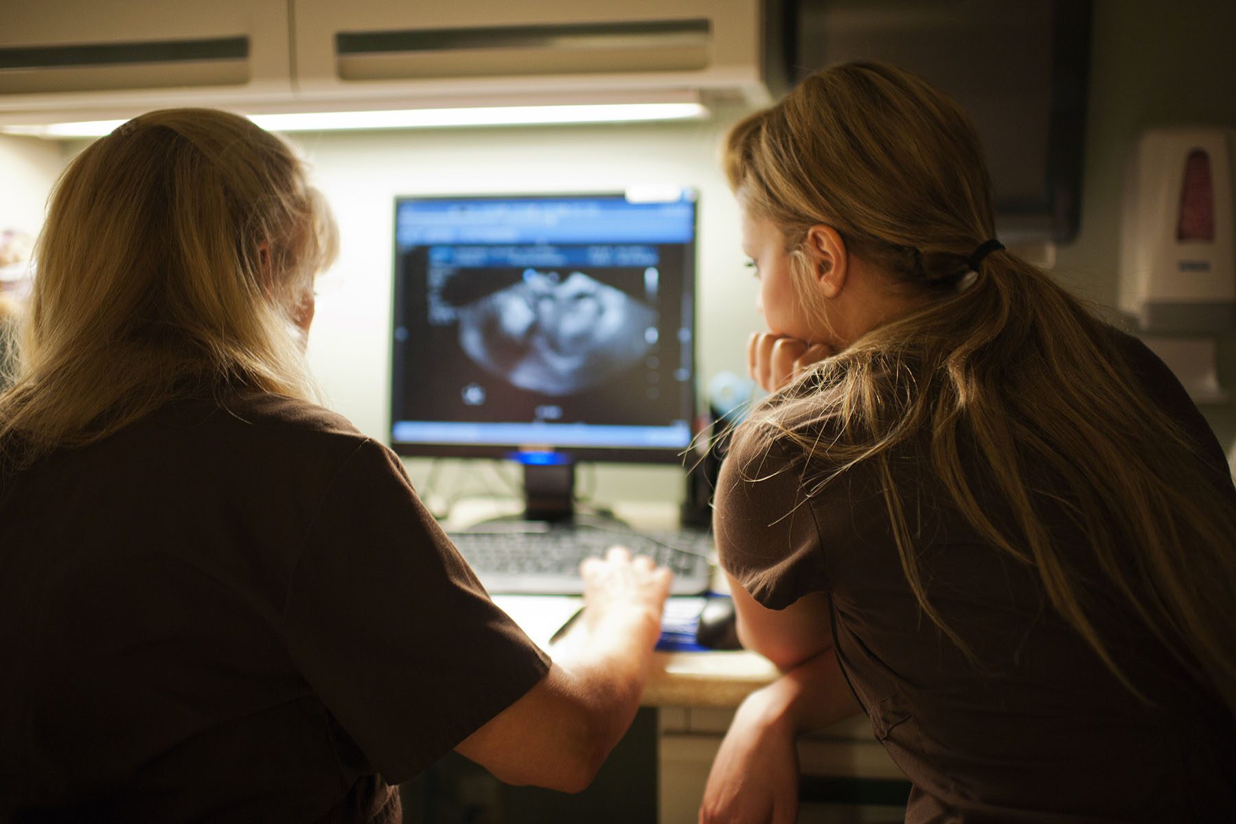 Two nurses discuss ultra sound results.