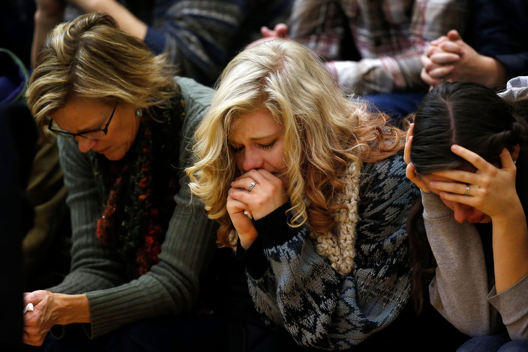 Women cry and during a vigil for those killed at the Planned Parenthood shooting.