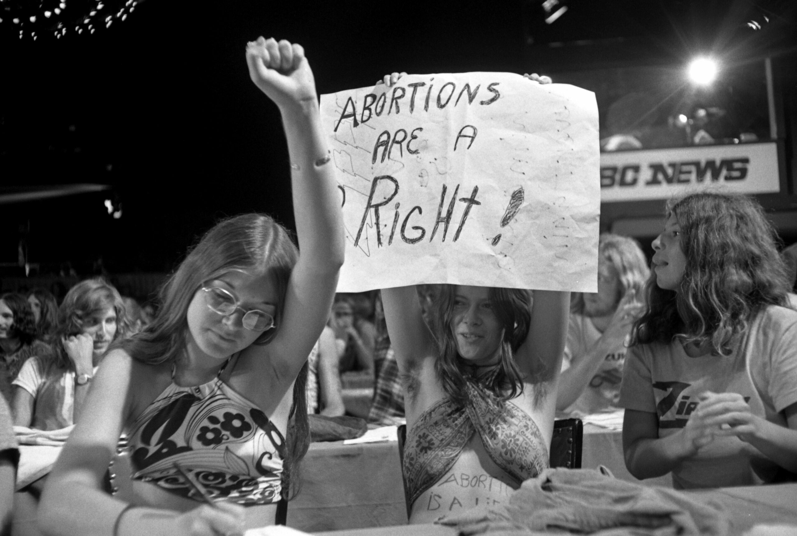 Protesters hold a sign that reads "Abortions are a right!"
