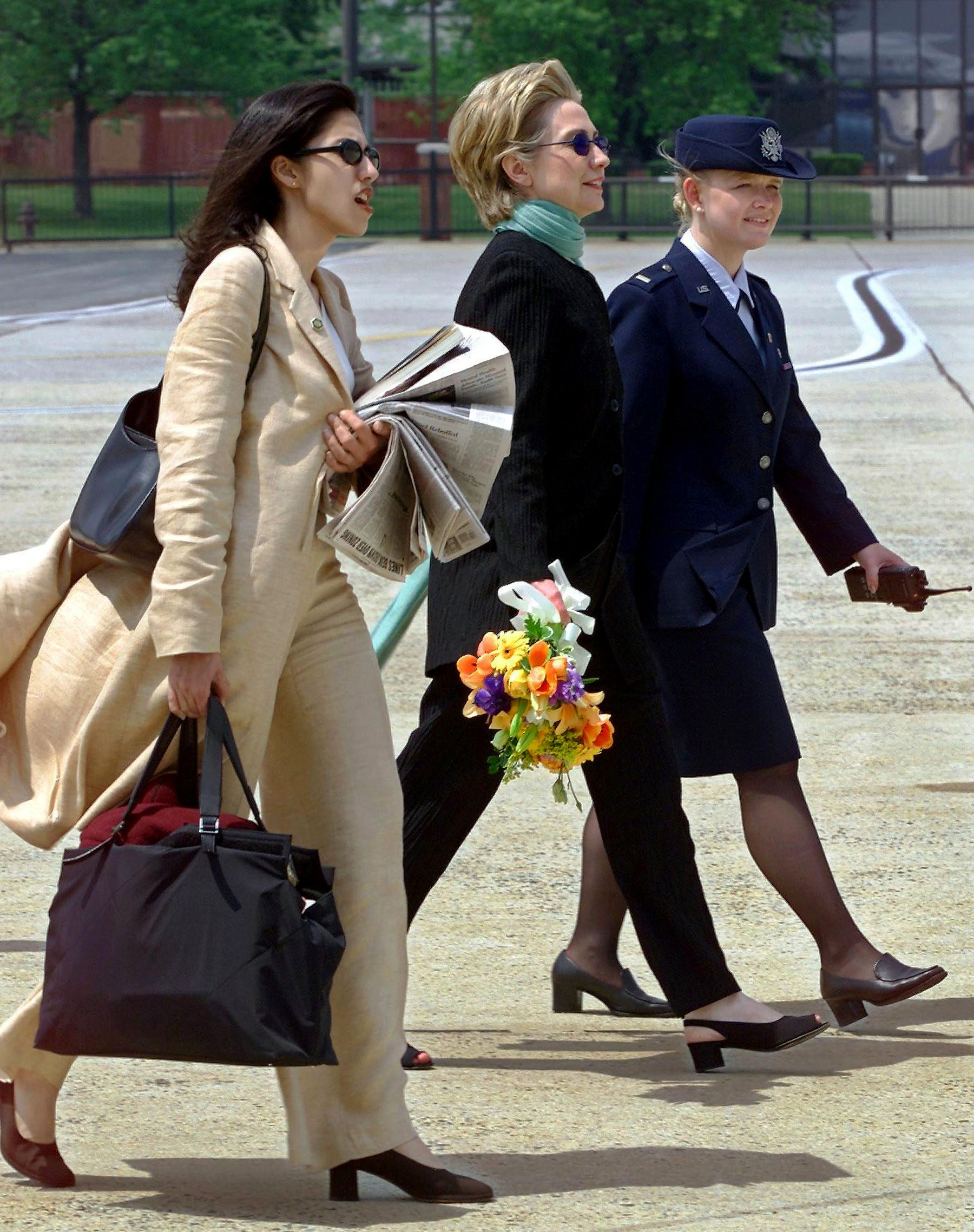 Huma Abedin and Hillary Clinton walk on the tarmak after a flight.