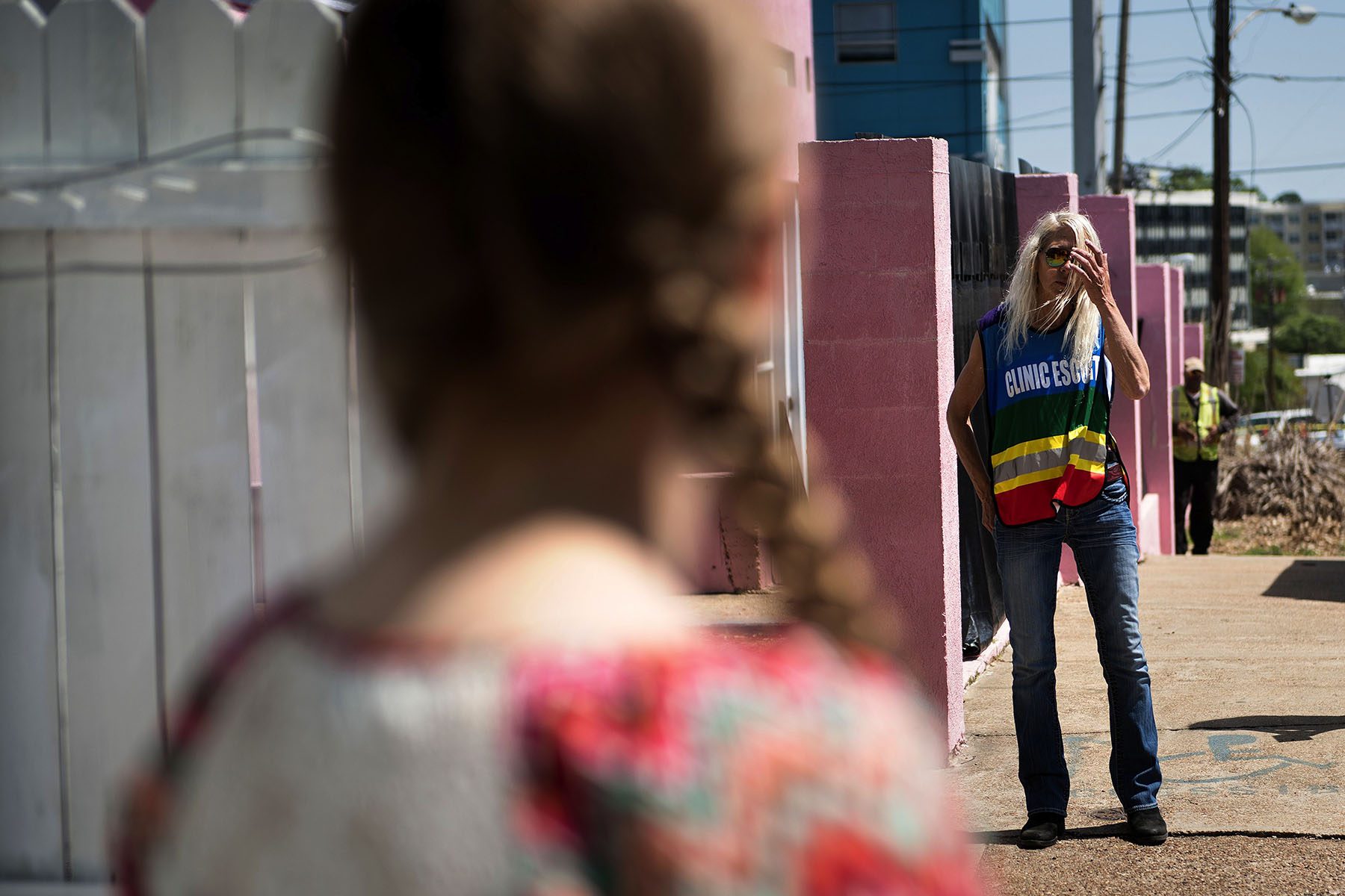 An anti-abortion activist looks towards a volunteer clinic escort.