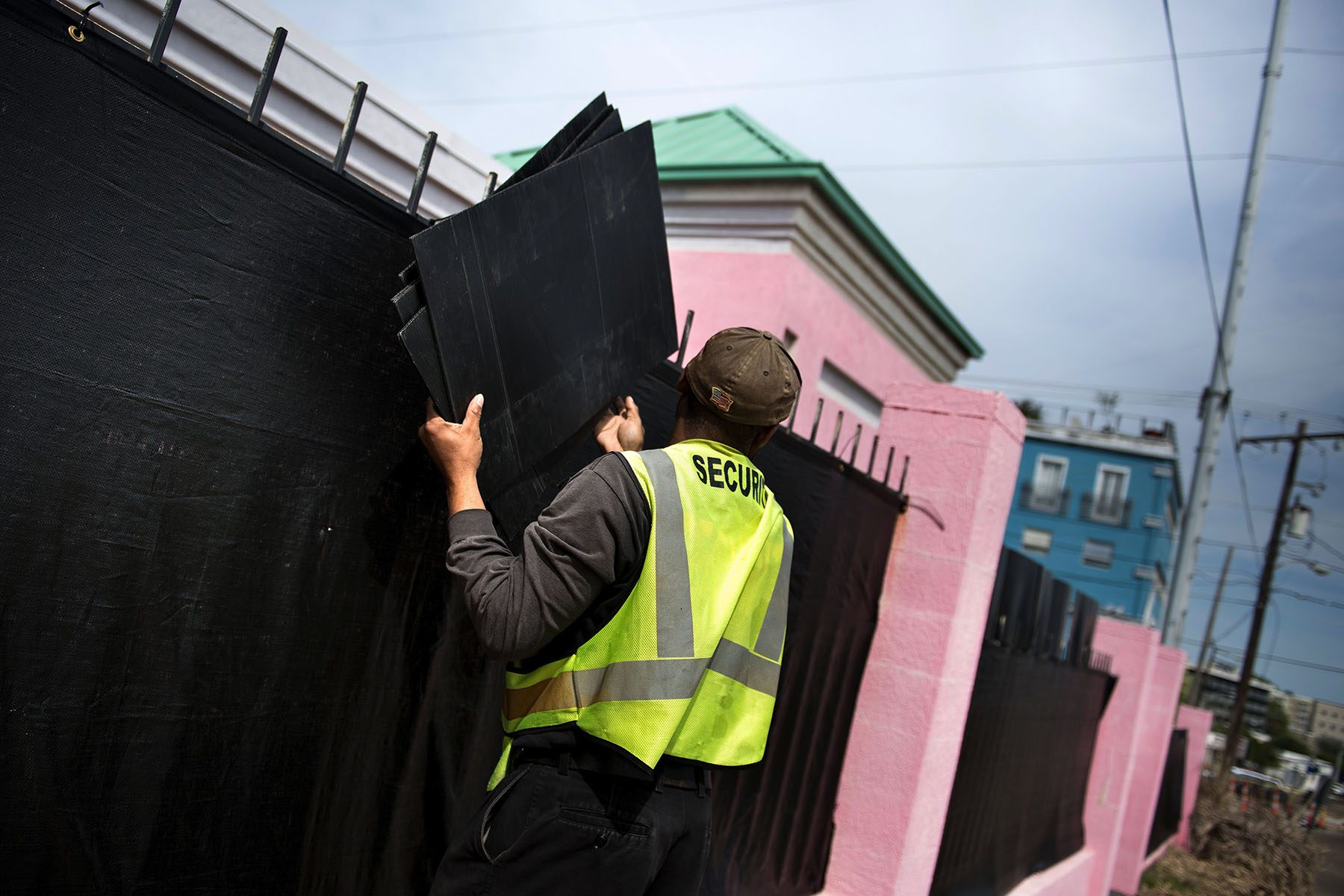 A security guard removes boards used to protect patient privacy.