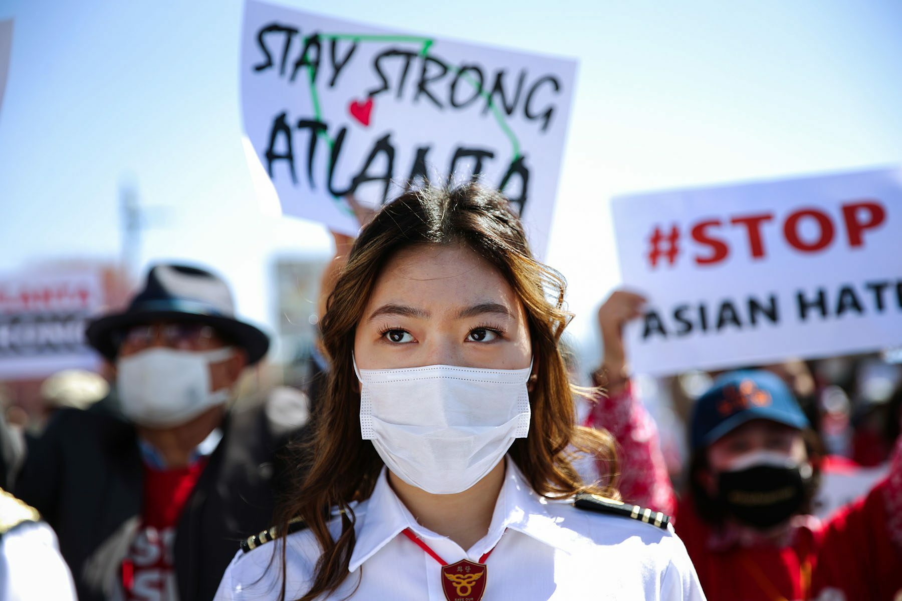 A woman wearing a face mask is pictured at a demonstration.