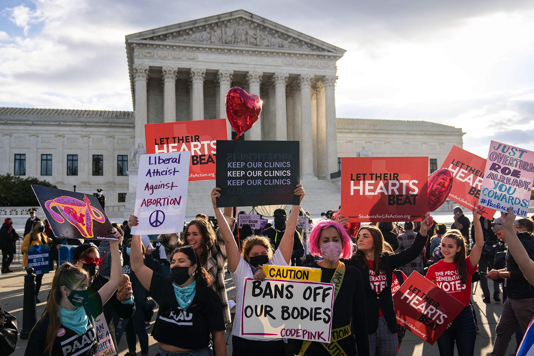 Abortion activists and anti-abortion demonstrators rally in front of the Supreme Court.