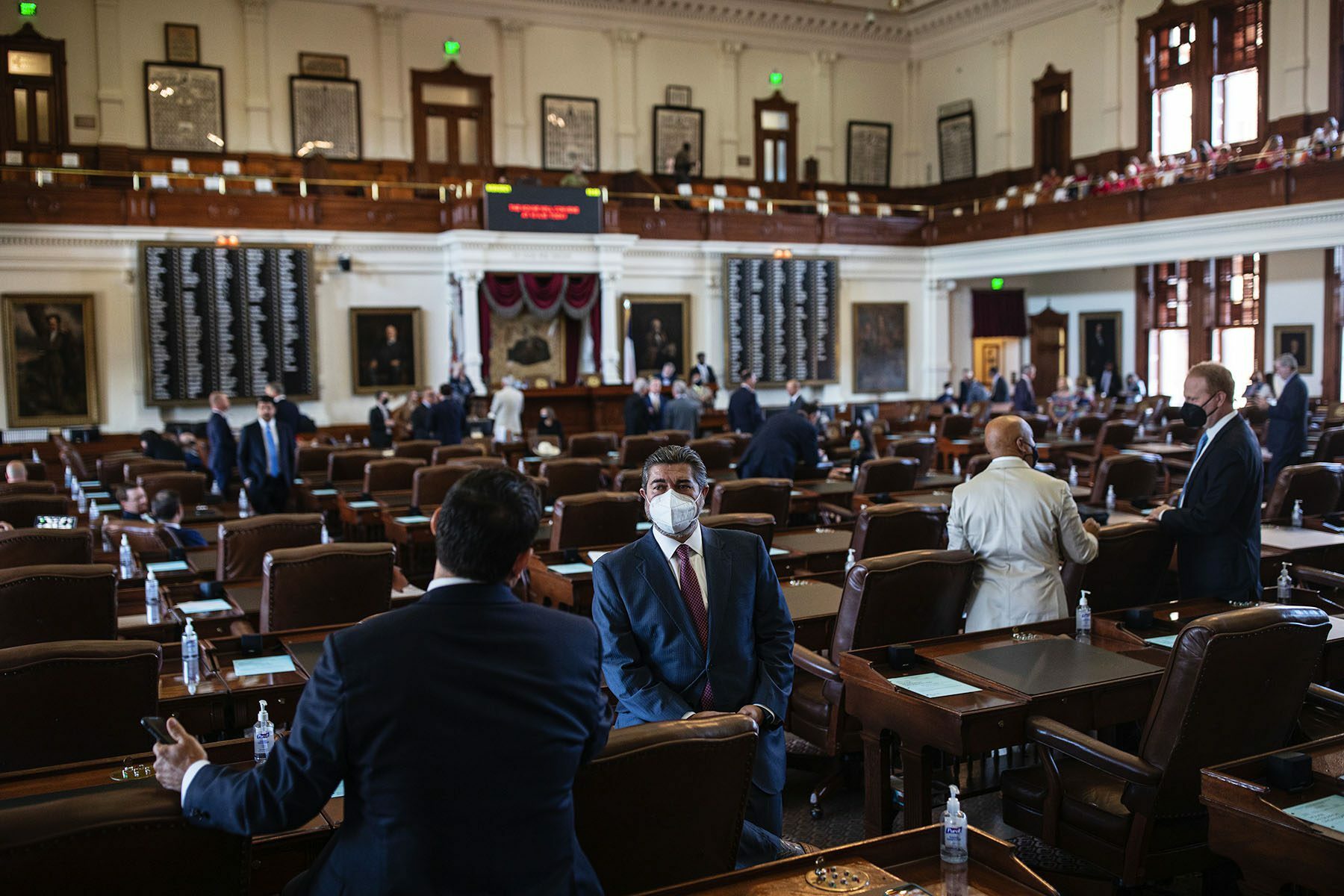 Texas state representatives gather in the House chamber.