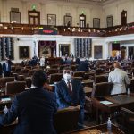 Texas state representatives gather in the House chamber.