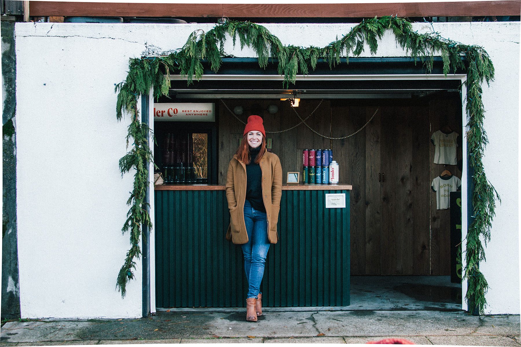 Caitlin Braam poses in front of her small business, Yonder Cider.