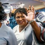 Stacey Abrams smiles and waves as meets Georgia voters.