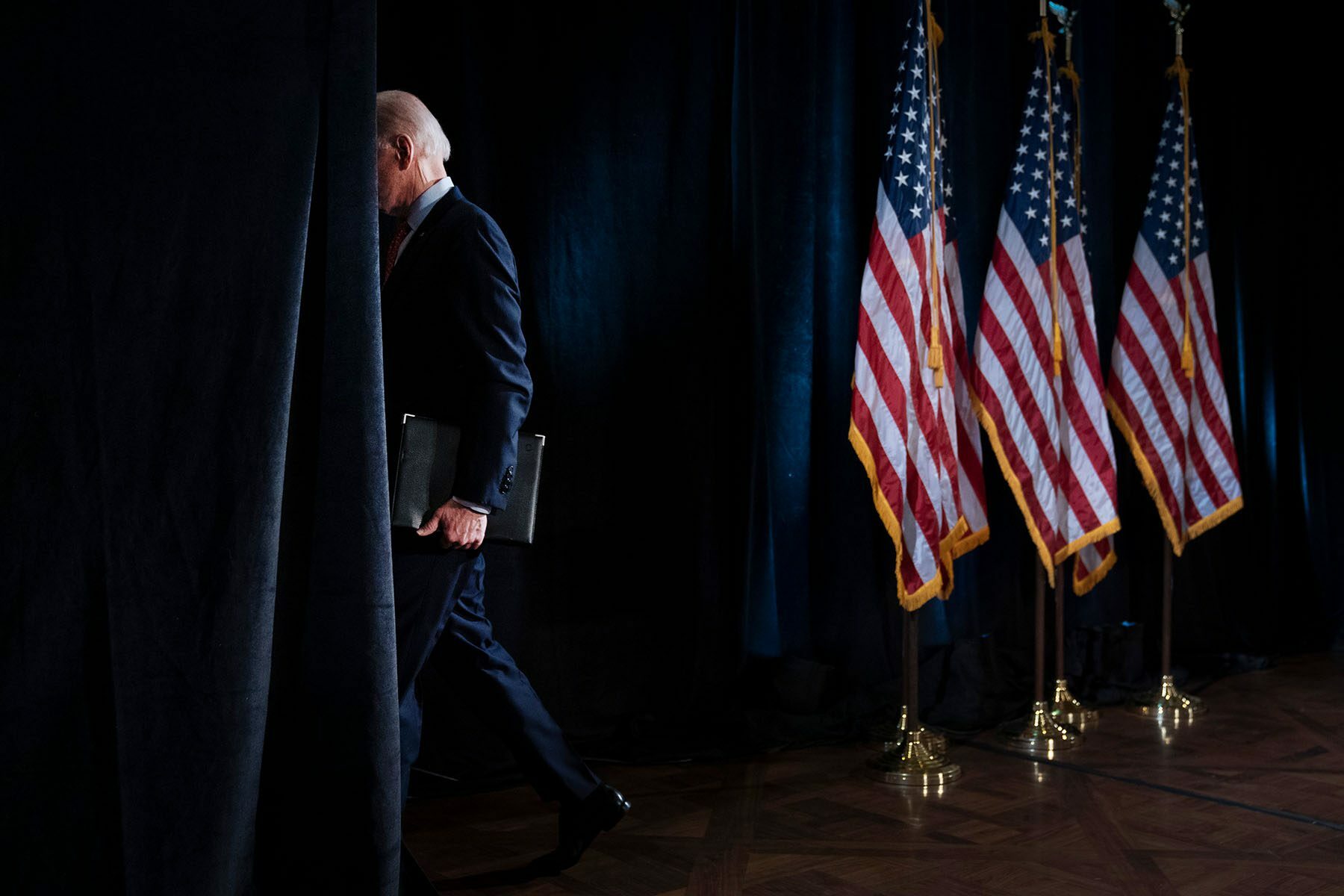President Biden walks off stage after delivering remarks to the press.
