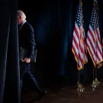 President Biden walks off stage after delivering remarks to the press.