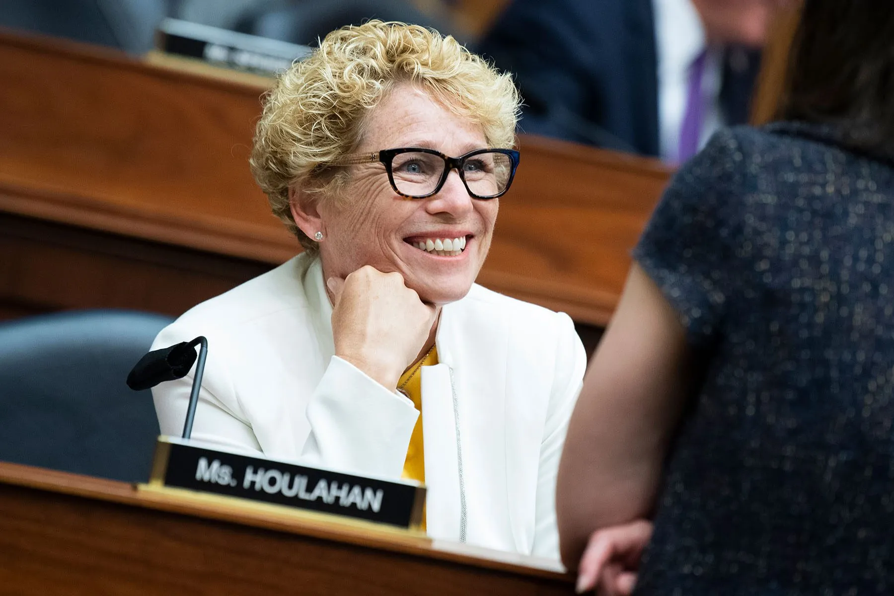 Chrissy Houlahan smiles at a colleague before a hearing.