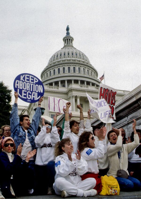 Demonstrators with the March for Women's Lives hold signs in front of the Capitol in 1989