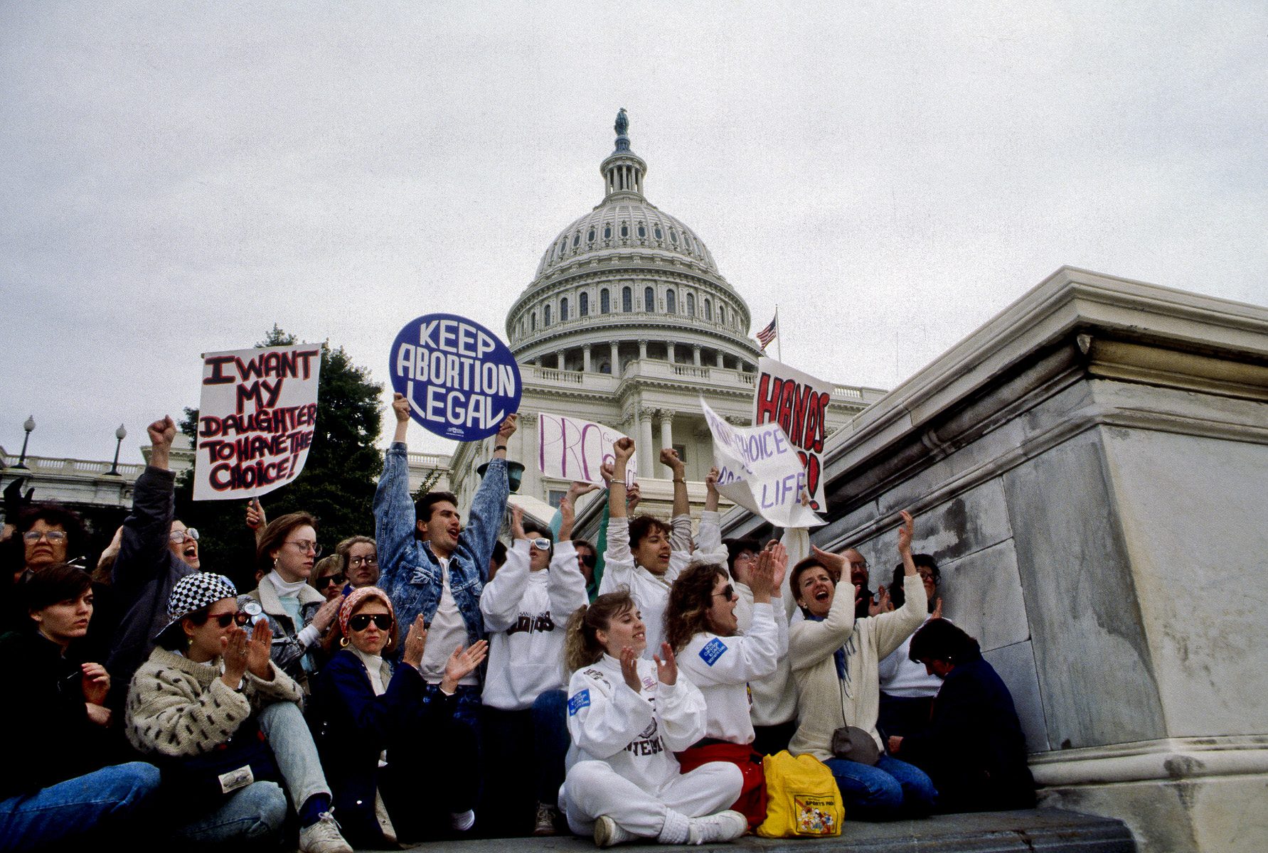 Demonstrators with the March for Women's Lives hold signs in front of the Capitol in 1989