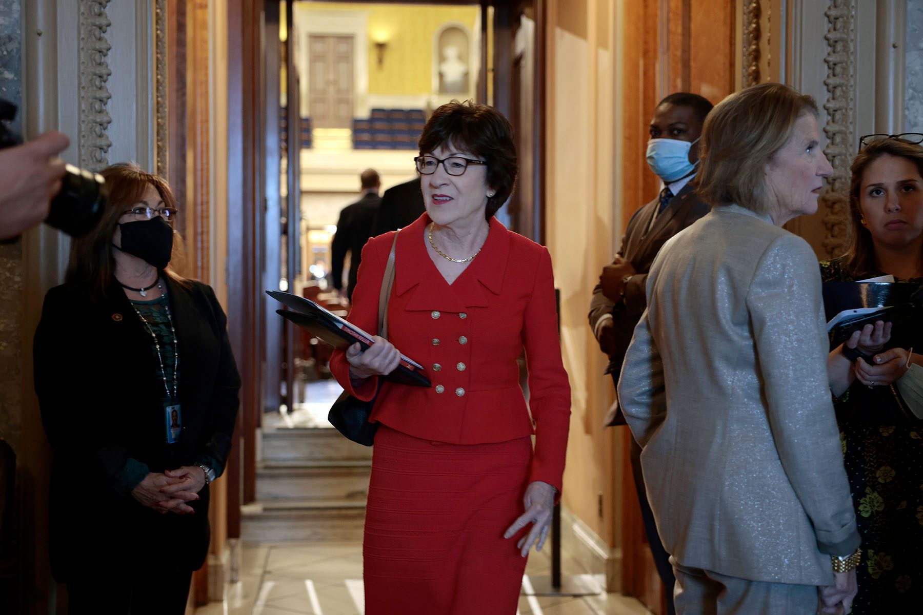 Sen. Susan Collins smiles as she speaks to reporters on Capitol Hill.