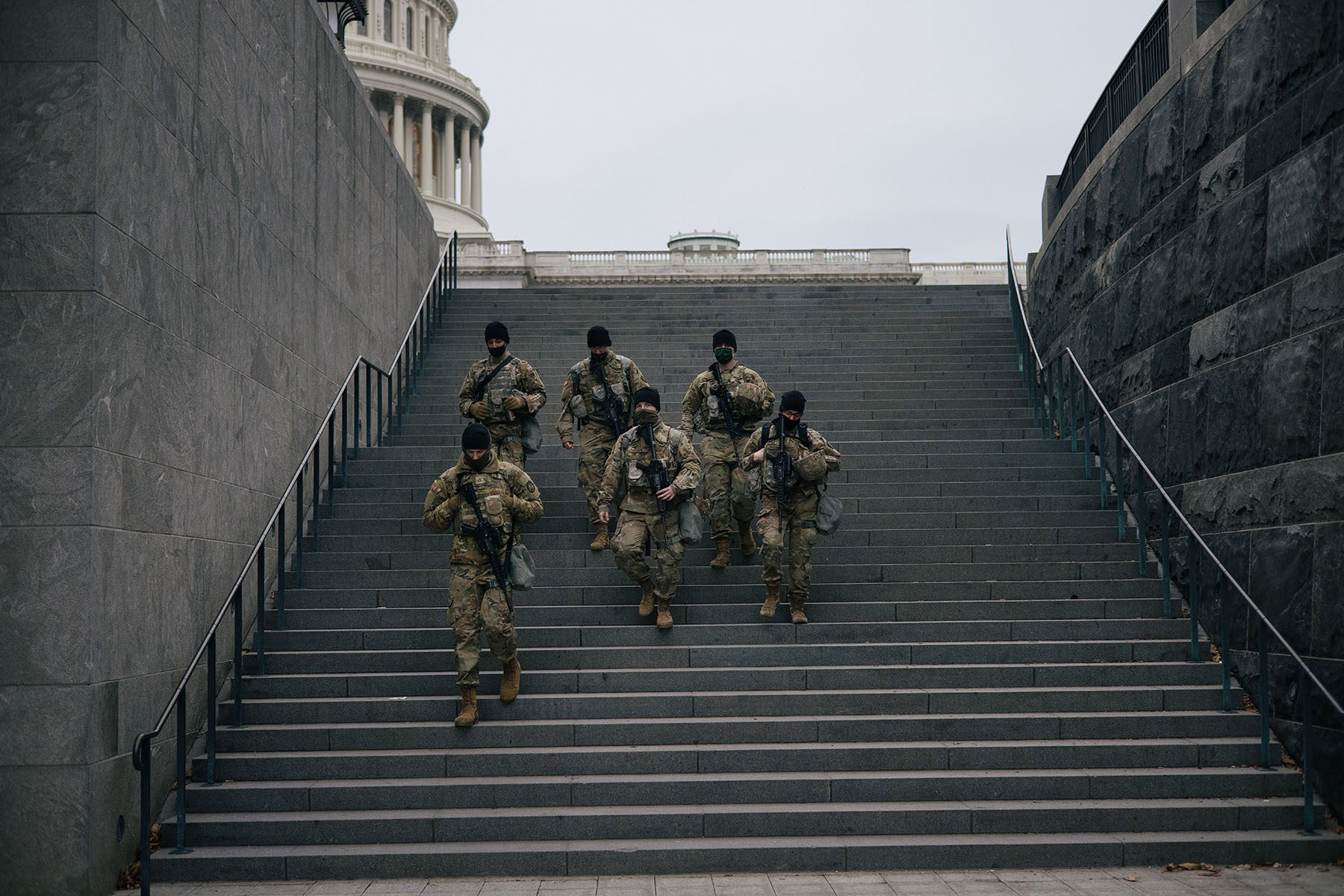 National Guard soldiers walk across the U.S. Capitol during a shift change.
