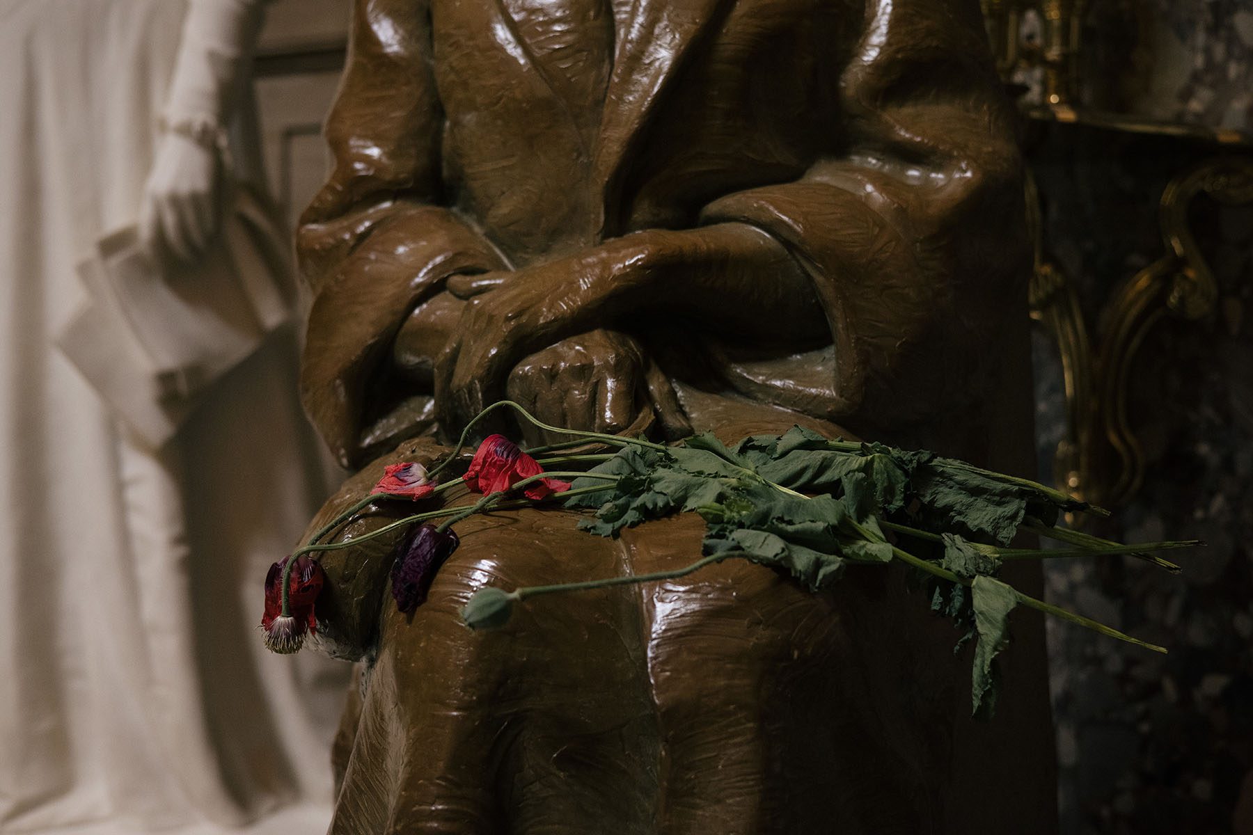 Roses dry on the lap of a statue of civil rights icon Rosa Parks.