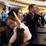 Del. Kathy Tran holds her daughter while being sworn in
