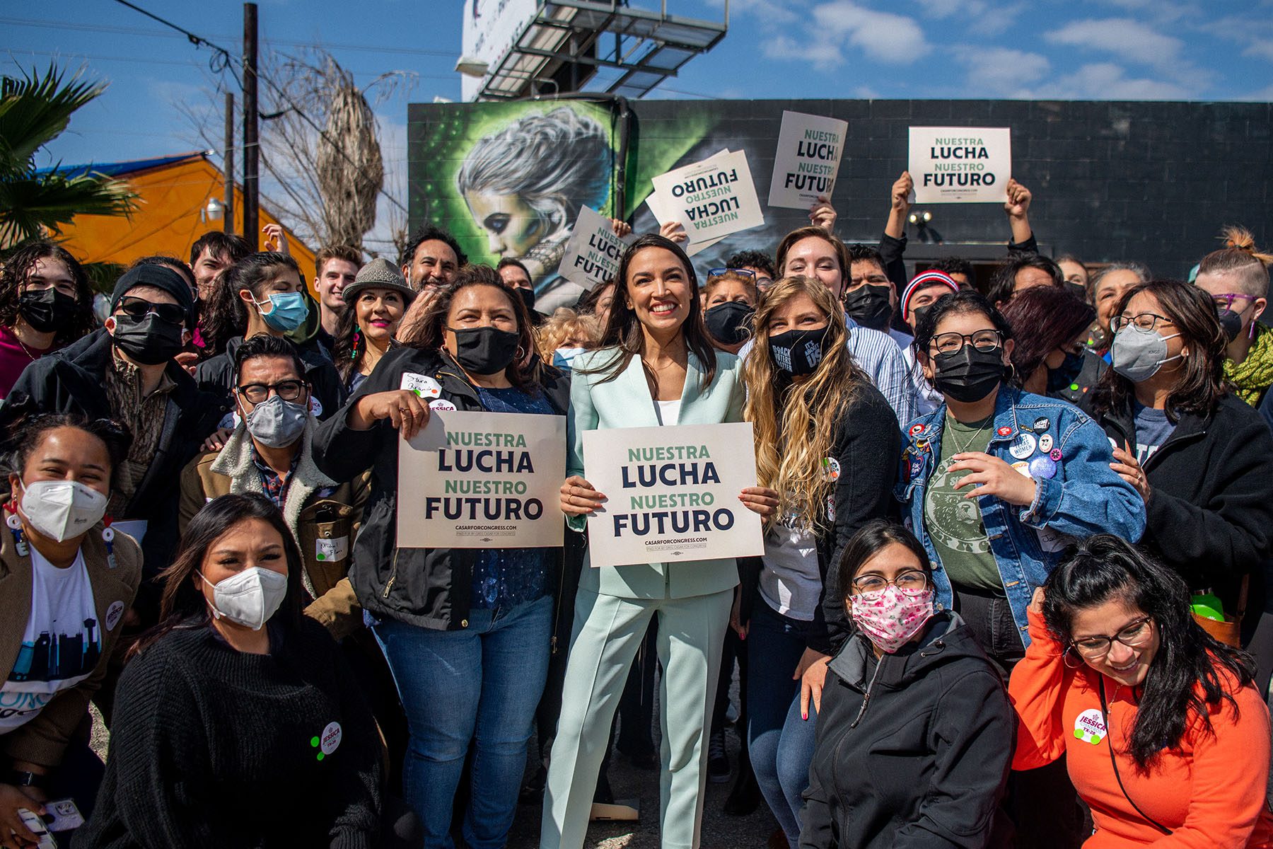 Rep. Alexandria Ocasio-Cortez poses for pictures with supporters.