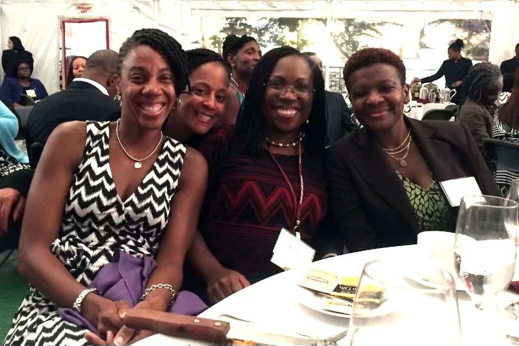 Lisa Fairfax, Nina Simmons, Ketanji Brown Jackson and Antoinette Coakley smile and pose for a picture at the Harvard Law School Celebration of Black Alumni.