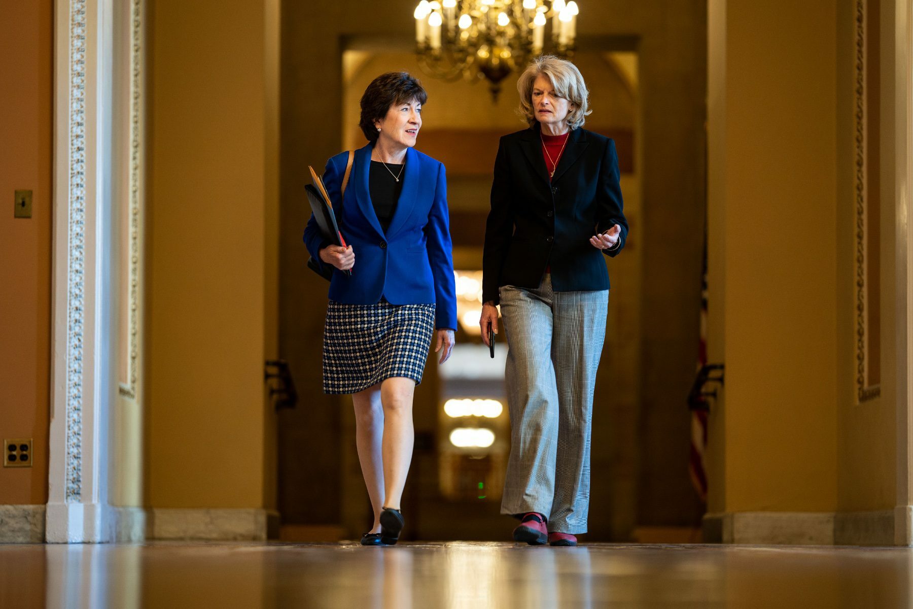 Sen. Susan Collins walks with Sen. Lisa Murkowski on Capitol Hill.