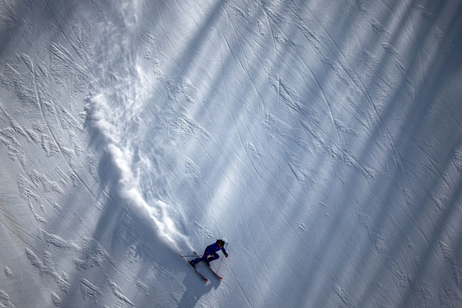An athlete skies down a snowy slope during practice.