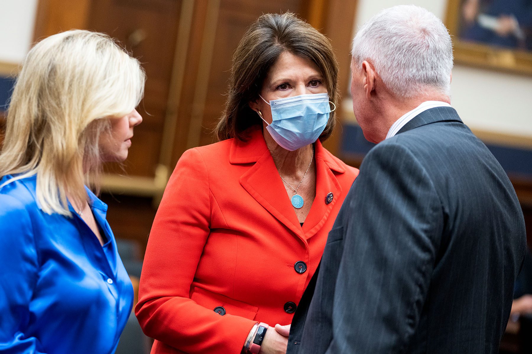 Gretchen Carlson, Cheri Bustos and Ken Buck speak amongst each other on Capitol Hill.