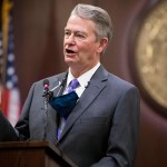 Idaho Governor Brad Little gestures during a press conference.