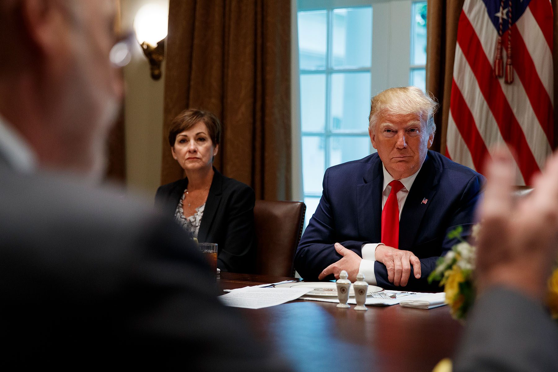 Gov. Kim Reynolds and former President Trump sit together during a meeting at the White House.