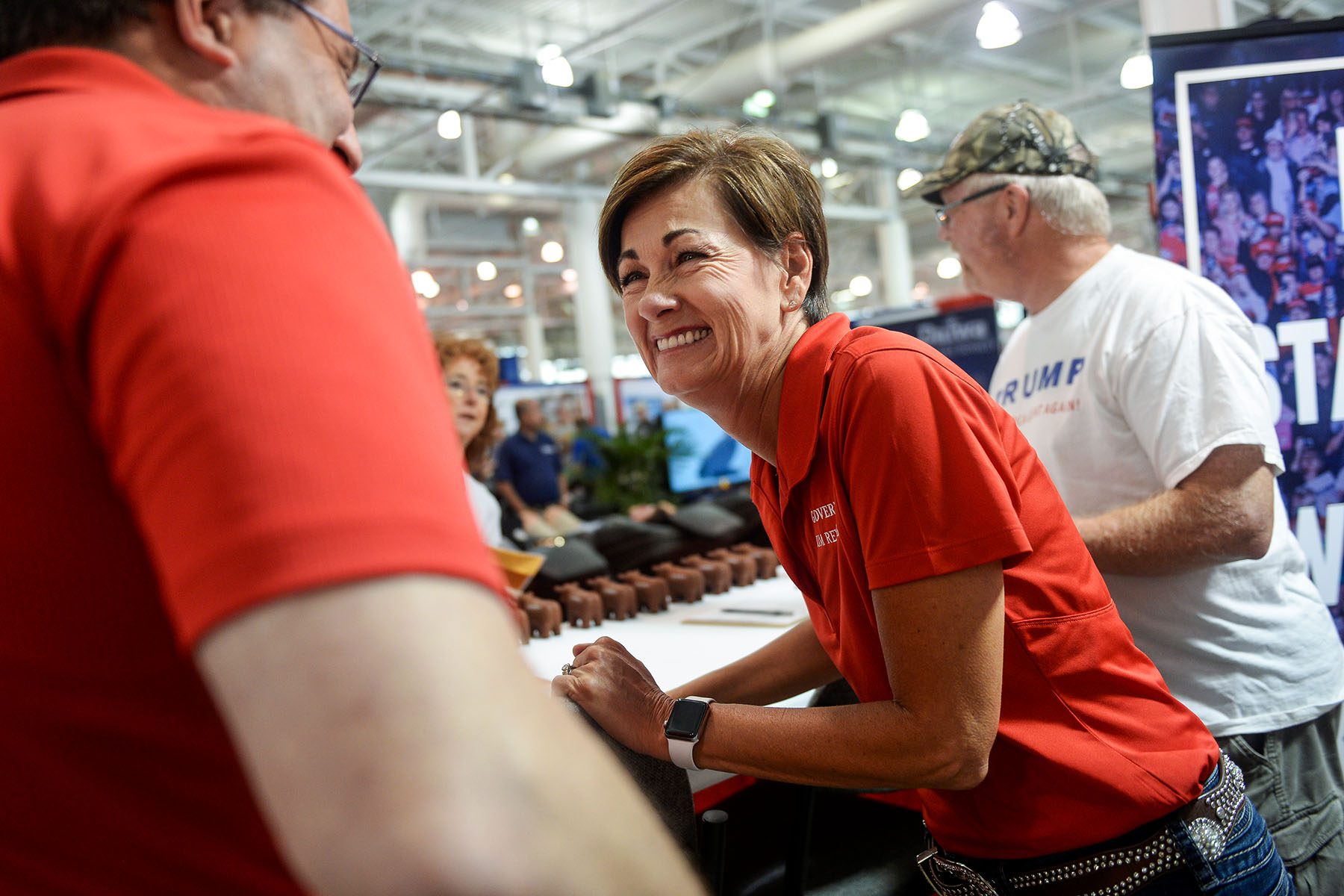 Gov. Kim Reynolds laughs while conversing with Jeff Kaufmann and the Iowa State Fair.