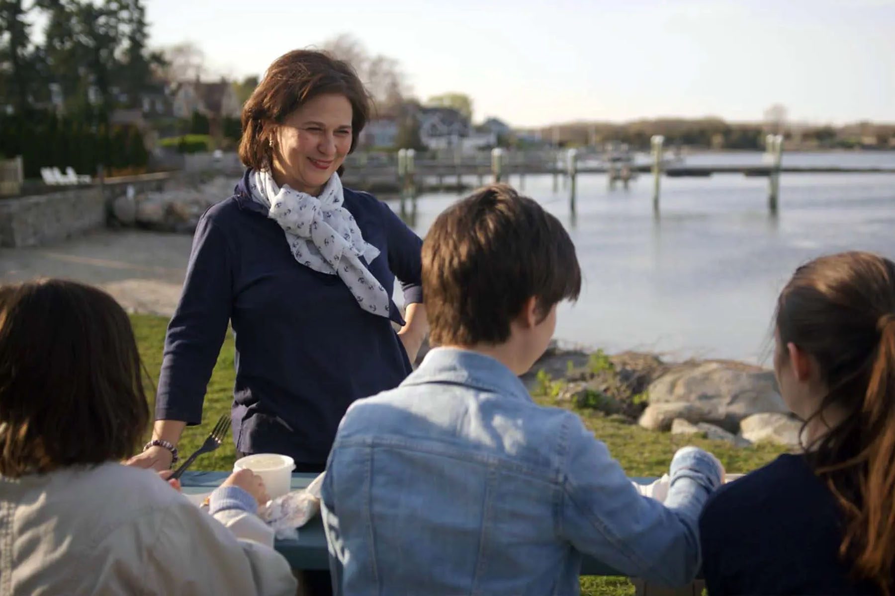 Nellie Gorbea shares a meal with young constituents by the water.